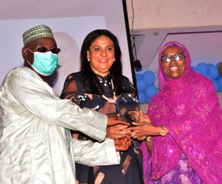 The Guest Lecturer, Mrs. Clare Omotseye (middle) receiving her award from Prof. Hamisu Salihu and assisted by Prof. Hadiza Galadanci (right)